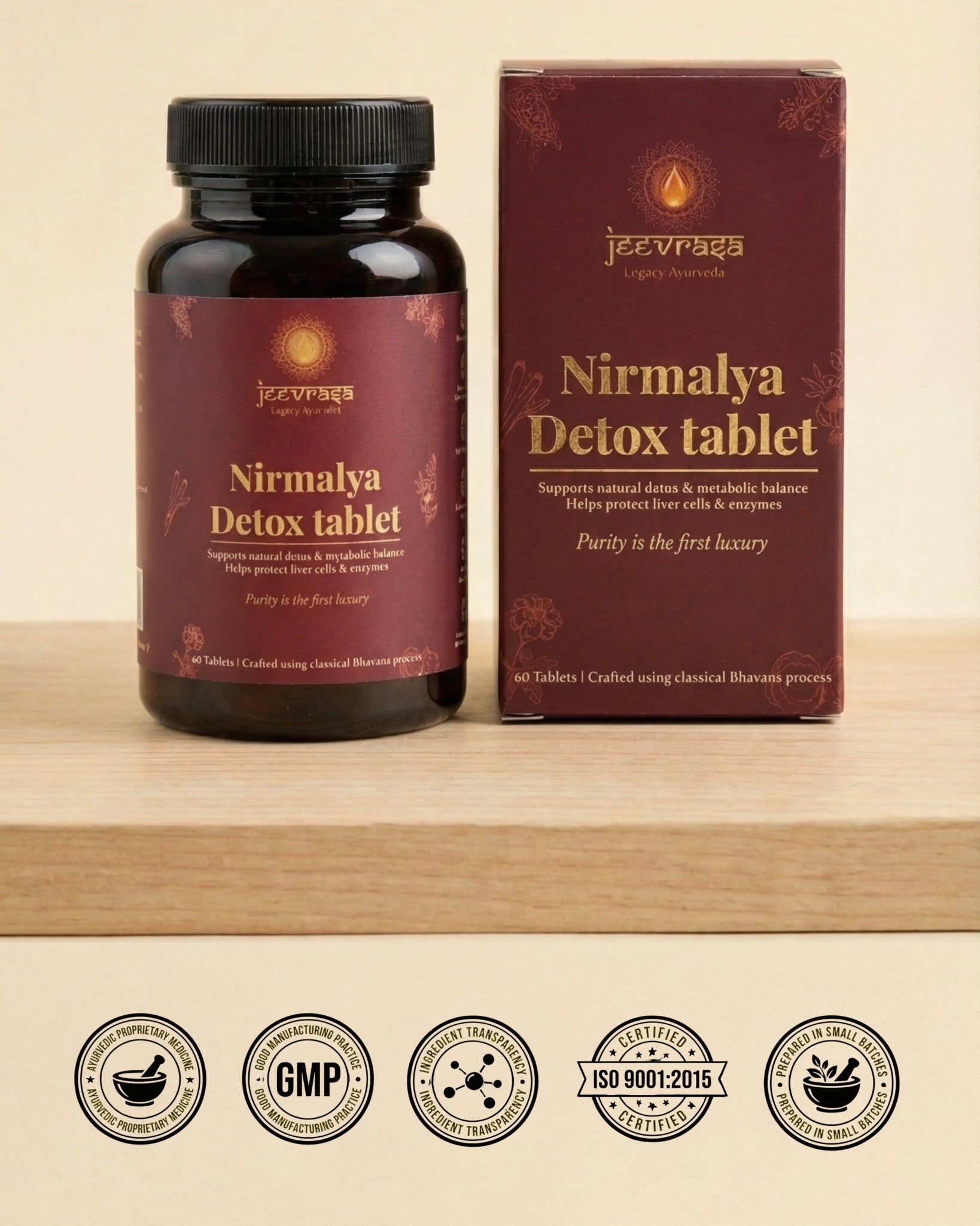 Nirmalya Detox tablet bottle and packaging on a wooden surface with certification logos at the bottom.